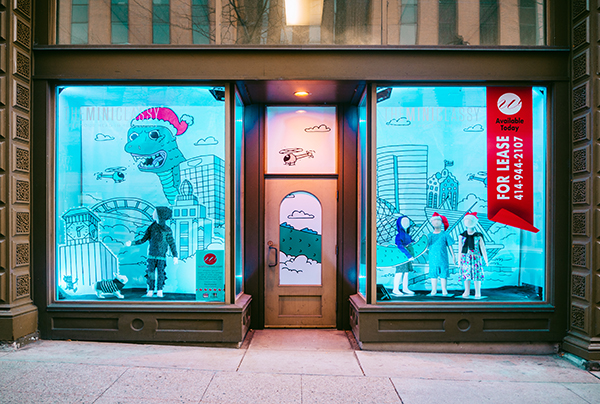 Holiday window display featuring children's apparel retailer, designed by Retailworks Inc.