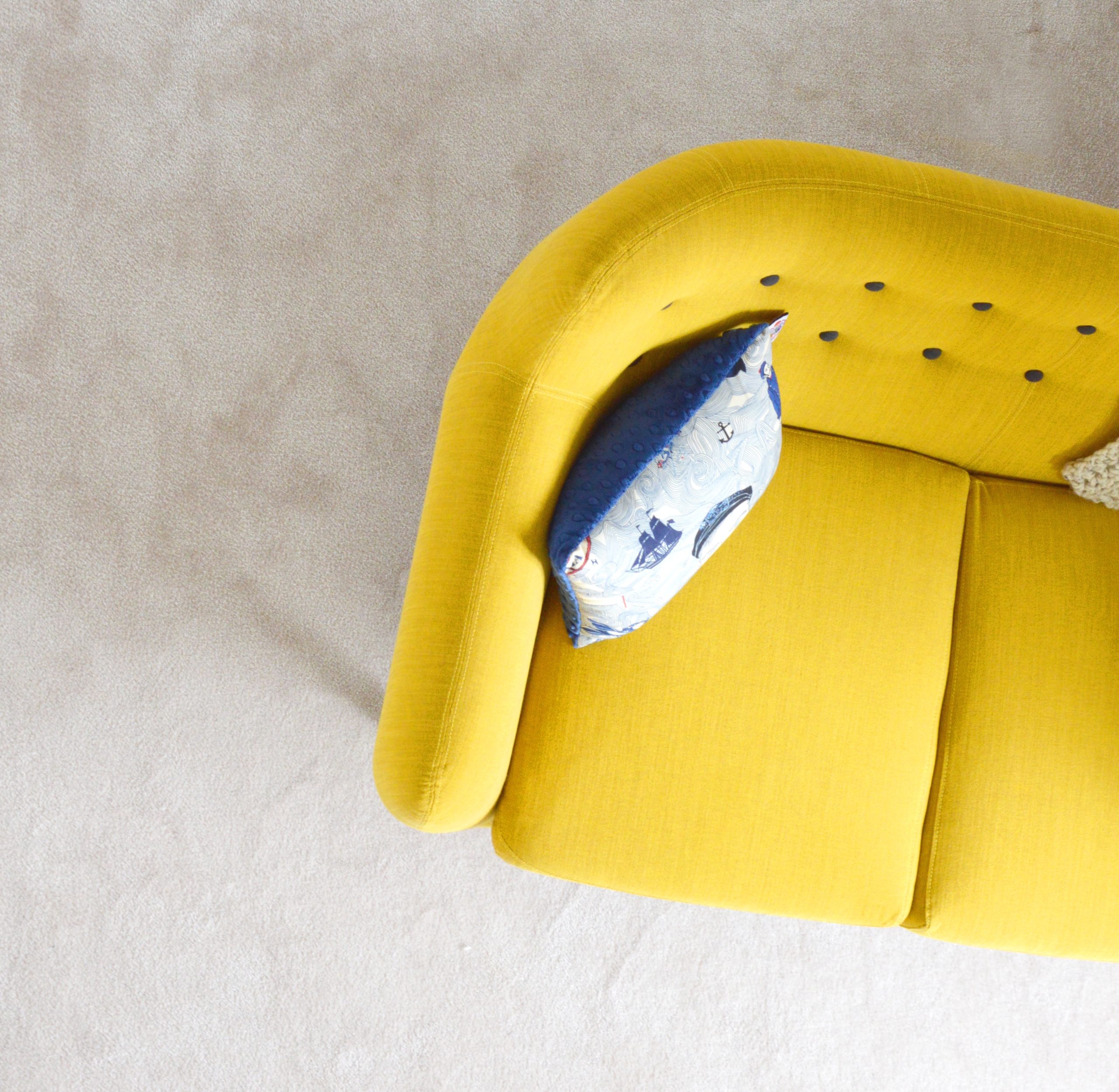 Yellow couch with pillow