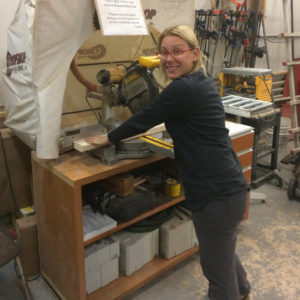 A Retailworks Inc. display artist sawing pieces for a window display