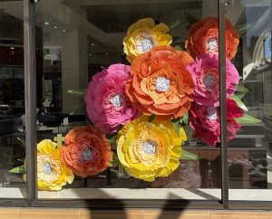 Window display of oversized peonies