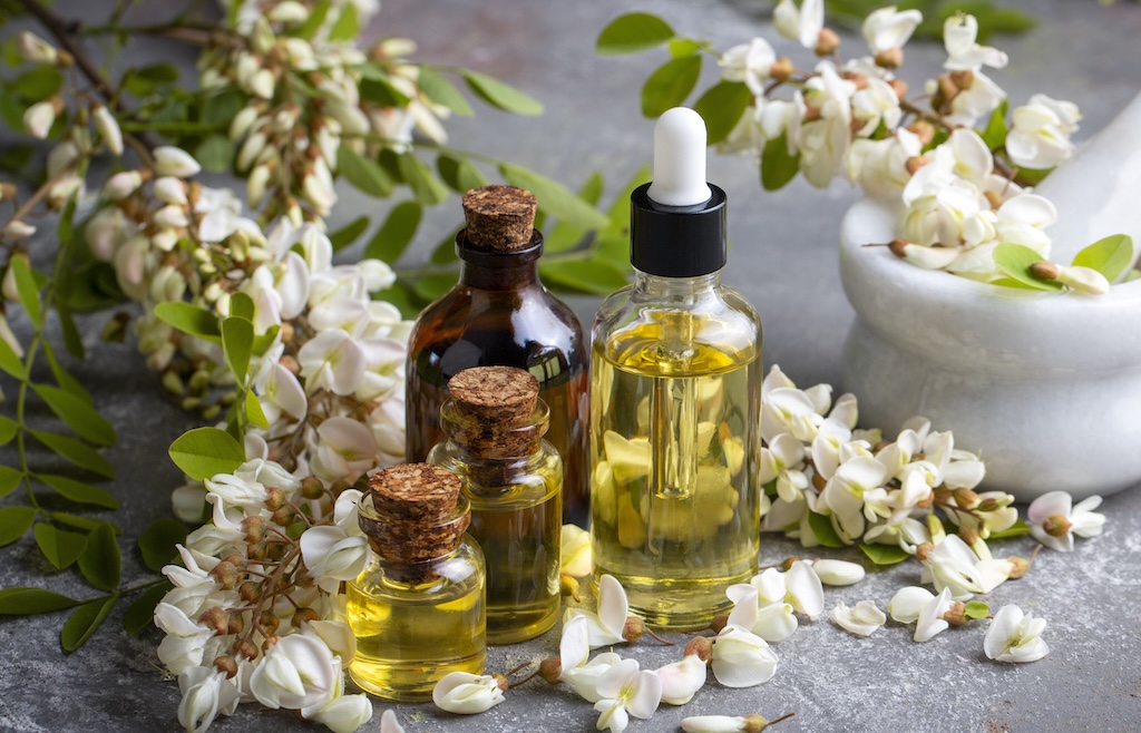 Three bottles of aroma oils with flowers